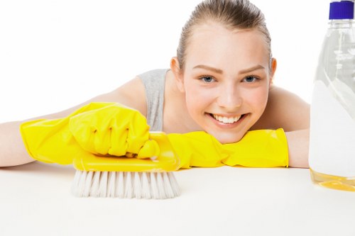 Cleaner using approved products with safety precautions in place